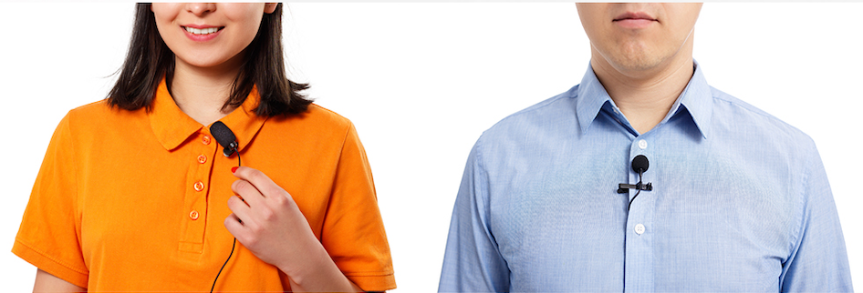 A woman in orange and man in blue show how to clip a lapel microphone onto their collared shirts