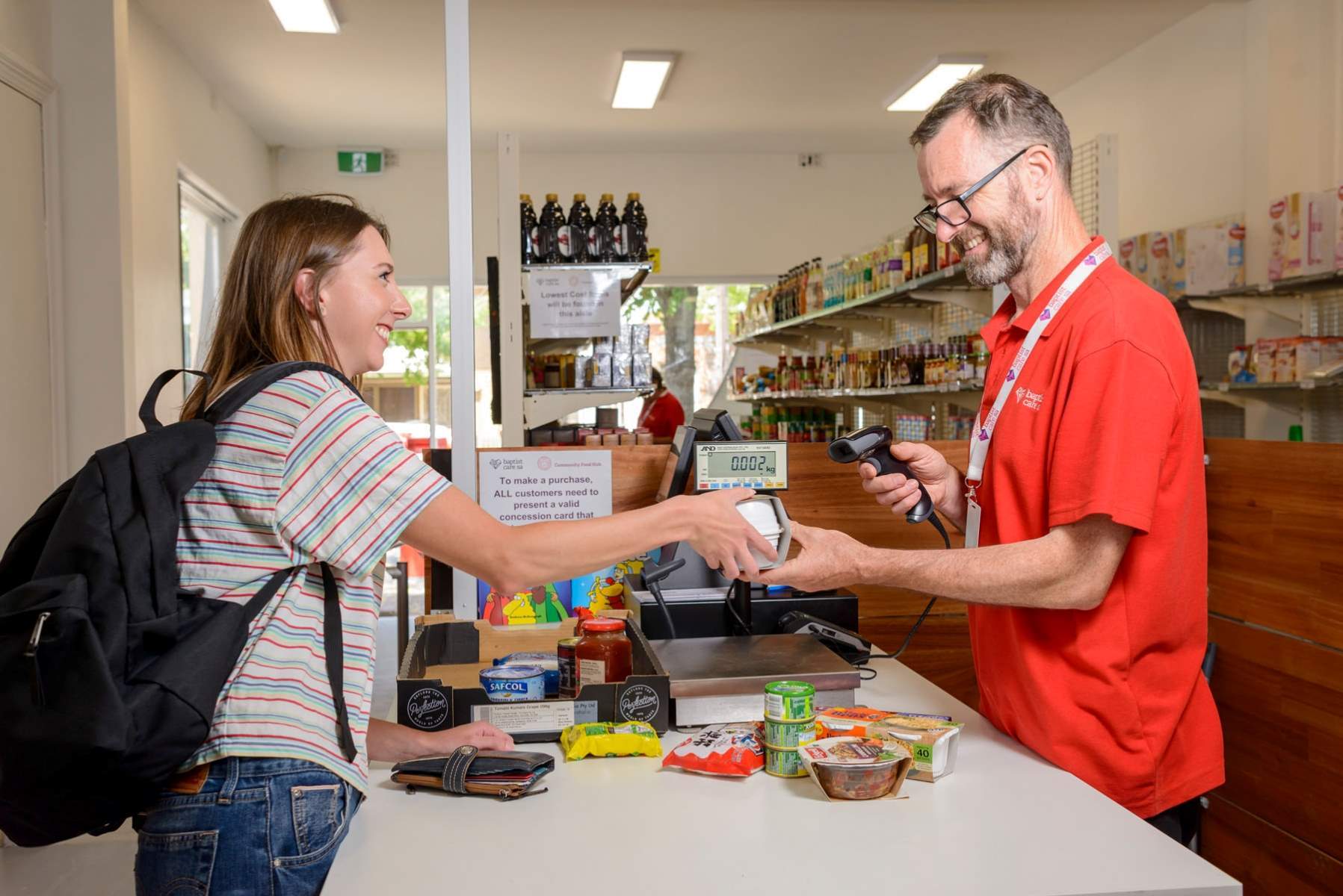 Student making purchase at Baptist Care SA Community Food Hub