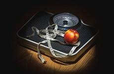Photo of scales, measuring tap and apple